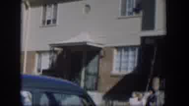 Nevada (1954): Front Doors And Windows Of Family Style Townhouses And A Vehicle