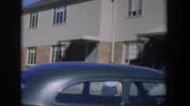 Nevada (1954): View Of Two Storey Houses With Car Roof In Foreground