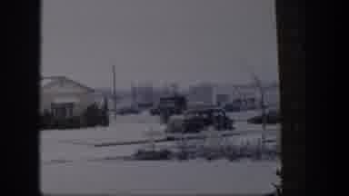 Nevada (1954): Winter City Scene Of Buildings Parked Cars Traffic Going By Snow On