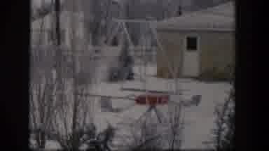 Nevada (1954): Snowy Residential Landscape With Bare Trees A Swing Set And Chairs