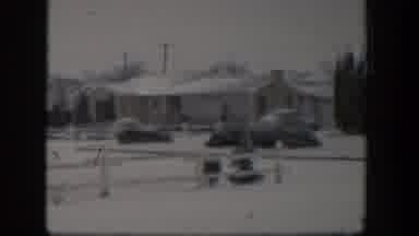 Nevada (1954): View Of Snow Covered Houses And Shrubs On A Cloudy Day