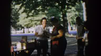 Nevada (1954): Group Of People Gathered In Park Near Picnic Bench Food Thermos On