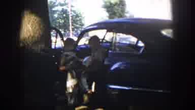 Nevada (1954): Guys Talking Next To A Vintage Car With The Door Open