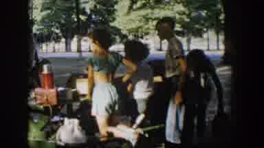 Nevada (1954): Woman Wearing White Shirt Places Items On Picnic Table On A Sunny