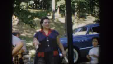 Nevada (1954): Woman Wearing Grey And White Dress Stands Near White Picnic Table