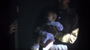 Nevada (1954): A Man Holding A Smiling Baby Because He Has A Woman Playing With