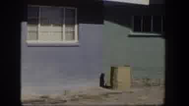 Nevada (1954): Blue Brick House With White Blinds On A Sunny Day Panning To The