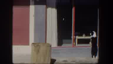 Nevada (1954): View Of Blue Car Parked Near Red And White Door On A Sunny Day