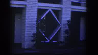 Nevada (1954): View Of White Lattice Structures And Shrubs On A Clear Evening