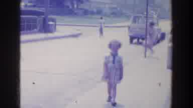 Ireland (1961): A Girls Spins Around A Pole Near The Streets With People Walking