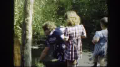 Washington DC (1948): A Woman And Her Two Kids Pick Plants From The Garden