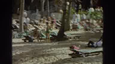 Puerto Rico (1966): People Lie On The Sand And In Hammocks Among Palm Trees Near A