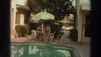 Puerto Rico (1966): Woman Stands At Edge Of Pool Looks In And Waves