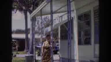 Puerto Rico (1966): There Is A Lady Standing On The First Porch Of A House