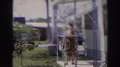 Puerto Rico (1966): A Chubby Woman Dressed In A Gown Walks On The Corridor Of A