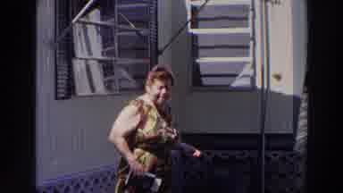 Puerto Rico (1966): Older Woman Showing Something By A House