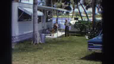 PUERTO RICO-1966: Couples Relaxing In Tropical Backyard With Classic Car
