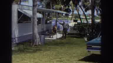 Puerto Rico (1966): Palm Trees And A Couple Sitting Outside Of Their RV Enjoying
