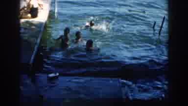 Brighton Michigan (1960): Boys Wade And Splash In Water Next To A Dock While A