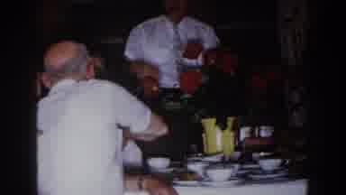 Brighton Michigan (1960): Man Wearing White Shirt And Glasses Stands Near Red