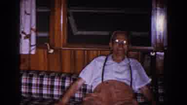Brighton Michigan (1960): Old Man Sitting On A Plaid Couch Glances At