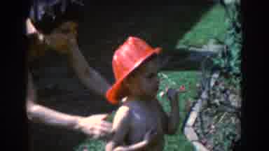 North Hollywood California (1961): A Boy Wearing A Red Hat Is Being Directed To