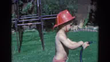 North Hollywood California (1961): Young Boy In Toy Firefighter Hat Plays With