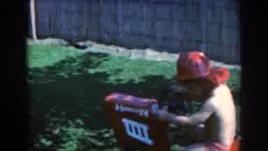 North Hollywood California (1961): Baby Wearing A Red Hat While Playing With A Toy