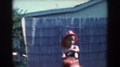 North Hollywood California (1961): Toddler Wearing Red Hat Plays With Toy Red
