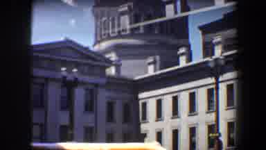 Saint Louis Missouri (1964): View Of Red Orange Bus Driving By Grey Building On A