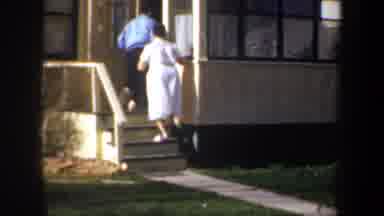 Wyoming (1957): Man And Woman Enter House As Cat Walks Across Front Lawn