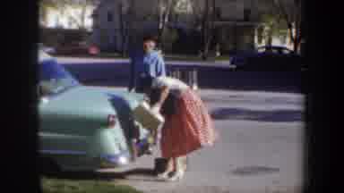 Wyoming (1957): Woman With Boxes In Her Hands Tries To Open Car Trunk Man Comes