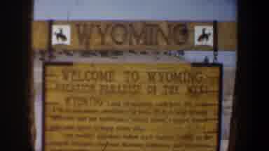 Wyoming (1957): A Road Sign Reads Welcome To Wyoming Is Sighted Besides The Road