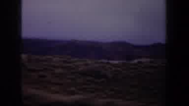 Wyoming (1957): Driving In Countryside Showing Oil Well And Mountains