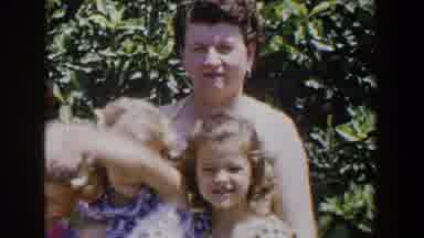 LUBBOCK TEXAS-1953: Mom Holding Two Daughters And One Son Sitting In The Garden