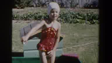 Lubbock Texas (1953): Little Girl In Swimsuit Playing In Shallow Pool And Standing