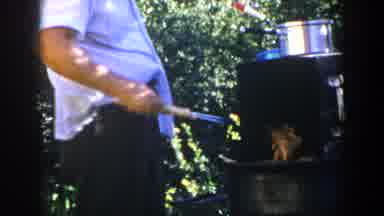 Lubbock Texas (1953): A Man Prepares A Meal In The Open While His Son Keeps Him