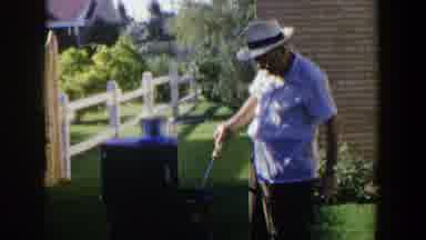 Lubbock Texas (1953): Elderly Man In White Hat Outdoors In Yard Cooking Meat On A
