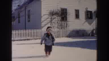 Dearborn Michigan (1961): Young Child Enjoys Looking And Playing With Snow In His