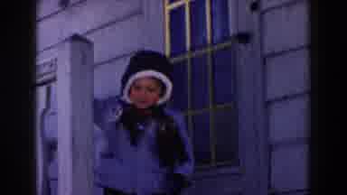 Dearborn Michigan (1961): Boy Wearing Blue Coat Stands In Front Of Wooden Door On