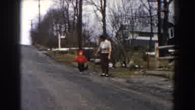 DEARBORN MICHIGAN-1961: Child in Red Coat Running with Mother on Gravel Road