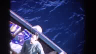 GIBRALTAR-1959: Man Wearing Green Shirt Stands In White Boat On Choppy Sea