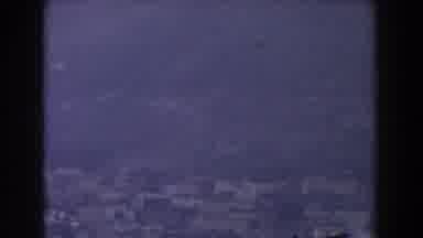 GIBRALTAR-1959: White Birds Fly Over A Coastline Sitting Below A Mountain Range