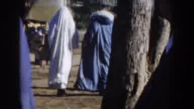 CASABLANCA-1959: Arab Men In Traditional Robes Walk Through A Sunlit Market