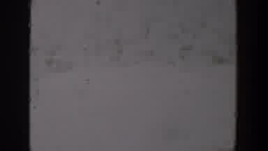 Lubbock Texas-1957: A Hazy, Degraded 8mm Film Frame With Scratches and Dust