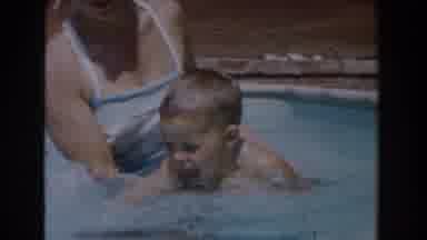 Van Nuys California (1962): Young Boy Learning To Enthusiastically Swim In A Pool