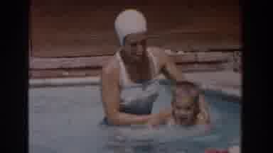 Van Nuys California (1962): A Women And A Child Play Together In A Pool As She