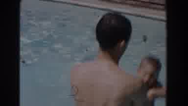 Van Nuys California (1962): A Man Lifts His Boy Up From The Pool During A Swimming