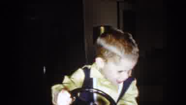 North Hollywood California-1961: Boy Wearing Yellow Shirt Plays With Red Toy Car