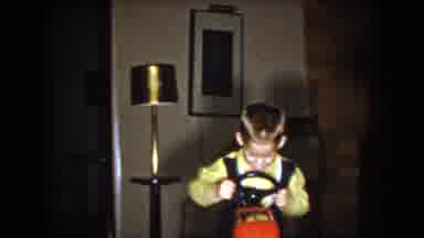North Hollywood California-1961: Boy Rides Toy Car With Smile In Living Room